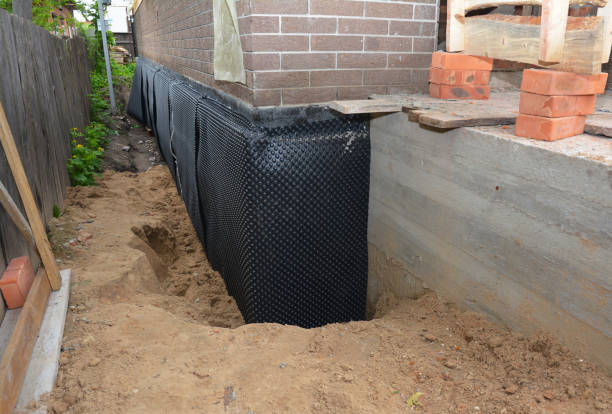 Happy homeowners after waterproofing job in Covington